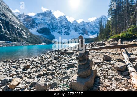 Rock Balancing, Stone Stacking Art. Moraine lake in autumn sunny day morning. Banff National Park, Canadian Rockies. Alberta, Canada. Stock Photo