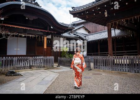 Japanese Kimono Portrait back view photography. Kyoto, Japan. Japanese traditional buildings background. Stock Photo