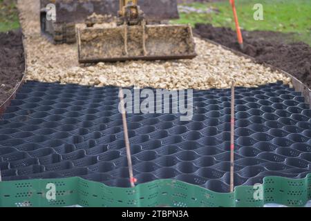 The construction of a pathway, driveway, with a tree root protection system, topped with lime stone Stock Photo