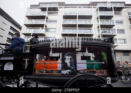 The funeral procession of Shane MacGowan makes its way along Pearse Street in Dublin ahead of his funeral in Co Tipperary. The songwriter, who found fame as the lead singer of London-Irish punk/folk band The Pogues, died at the age of 65 last week. Picture date: Friday December 8, 2023. Stock Photo