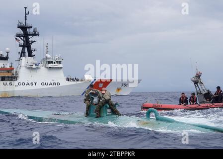 Eastern Pacific, United States. 20 November, 2023. U.S. Coast Guard boarding crew from the Coast Guard Cutter Waesche inspect a self-propelled semi-submersible drug submarine in international waters, November 20, 2023 in the Eastern Pacific Ocean. The submarine was found carrying more than 5,500 pounds of cocaine bound for the United States.  Credit: PO3 Hunter Schnabel/U.S. Coast Guard/Alamy Live News Stock Photo