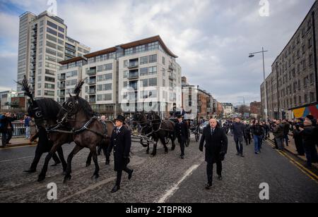 The funeral procession of Shane MacGowan makes its way over Mac Mahon Bridge in Dublin ahead of his funeral in Co Tipperary. The songwriter, who found fame as the lead singer of London-Irish punk/folk band The Pogues, died at the age of 65 last week. Picture date: Friday December 8, 2023. Stock Photo