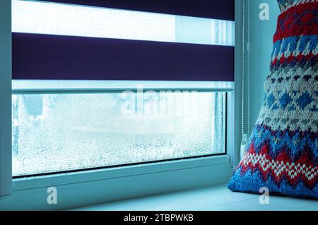 Drops of condensation on glass in winter. Metal-plastic window Stock Photo