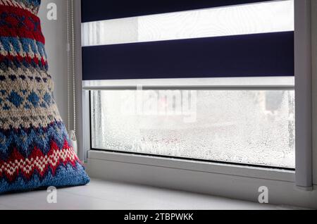 Drops of condensation on glass in winter. Metal-plastic window Stock Photo