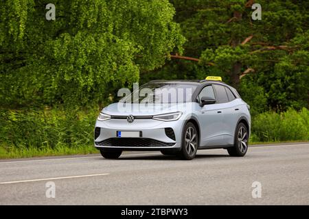 Silver Volkswagen ID.4 GTX 4-Motion taxi electric SUV car year 2023 on road in summer sunlight. Salo, Finland. July 6, 2023 Stock Photo