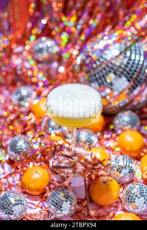 Festive Sparkling Wine styled for a vibrant disco party, New Year's Eve in pink, orange and red. Stock Photo