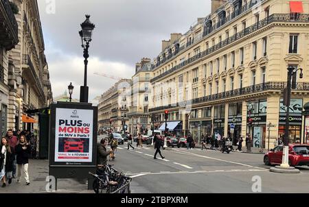 Paris, France. 08th Dec, 2023. On a billboard, the city of Paris informs about a citizen survey on increased parking fees for SUVs. Credit: Michael Evers/dpa/Alamy Live News Stock Photo