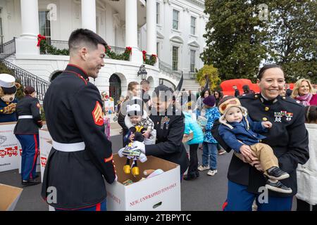 Washington, United States. 06th Dec, 2023. U.S. Marine Corps Sgt. Joshua Poulson, operations chief at Office of Marine Forces Reserve, mans a collection box during a Toys for Tots event hosted at the White House, December 6, 2023 in Washington, DC Each year, the Marine Corps collects and distributes 8 million toys for children in 830 communities nationwide. Credit: Cpl. Ryan Schmid/U.S Marine Corps Photo/Alamy Live News Stock Photo