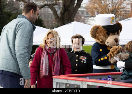 Washington, United States. 06th Dec, 2023. U.S. First Lady Jill Biden, left, and U.S. Marine Corps Brig. Gen. Valerie Jackson, right, commanding general of 4th Marine Logistics Group, Marine Forces Reserve help guests off the ice rink during a Toys for Tots event hosted at the White House, December 6, 2023 in Washington, DC Each year, the Marine Corps collects and distributes 8 million toys for children in 830 communities nationwide. Credit: Cpl. Ryan Schmid/U.S Marine Corps Photo/Alamy Live News Stock Photo