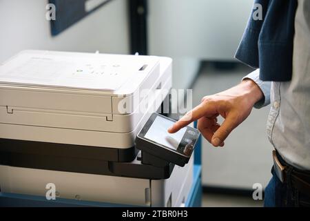 Employee uses office equipment to work with documents Stock Photo
