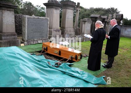 Glasgow Scotland Greek Orthodox Funeral at Glasgow Necropolis - Priest Reading the Committal Prayers at Graveside Stock Photo