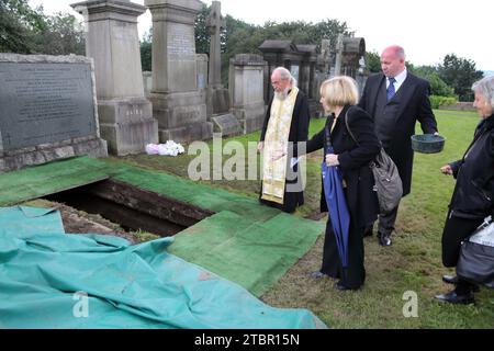 Glasgow Scotland Greek Orthodox Funeral at Glasgow Necropolis - Family Member Throwing Earth onto the Coffin Stock Photo