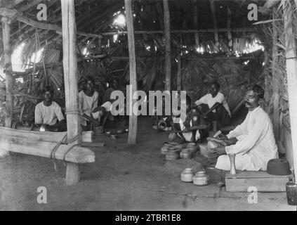 South India: boys and young men with leprosy making brass and copper utensils. The leper lads in their brass smithy. They make brass and copper utensi Stock Photo
