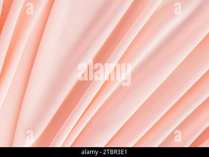 Elegant textile background in peach color with soft pleats. Festive background of the color of the year 2024 peach fuzz. A copy space Stock Photo