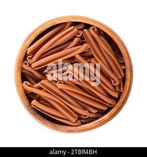 Casarecce pasta in a wooden bowl. Gluten free pasta, made with the flour of red lentils,  chickpeas and rice. Short twists of pasta. Stock Photo