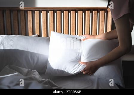 A hotel employee is tidying up the bedding Stock Photo