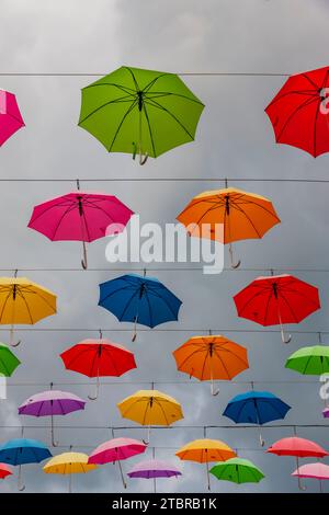 Colorful umbrellas in front of sky Stock Photo