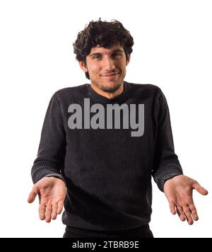 A man in a black sweater is holding his hands out, isolated on white background in studio shot Stock Photo