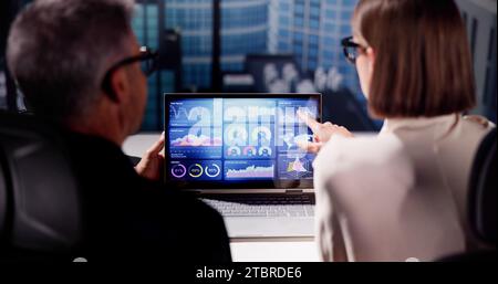 Analyzing KPIs and Report with Laptop's Graphs on Dashboard Stock Photo