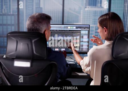 Working Analyst at Desktop PC with Spreadsheets Stock Photo
