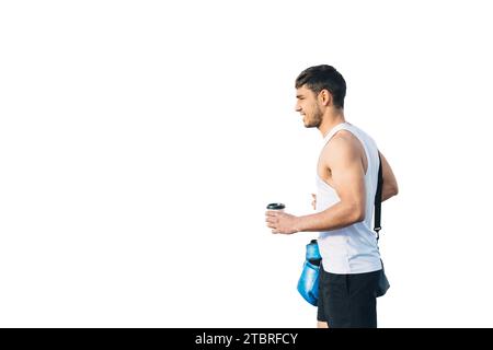 Horizontal photo man young adult mixed race walking to gym with sport clothes, a backpack, blue boxing gloves and a coffee to carry in hand. On white Stock Photo
