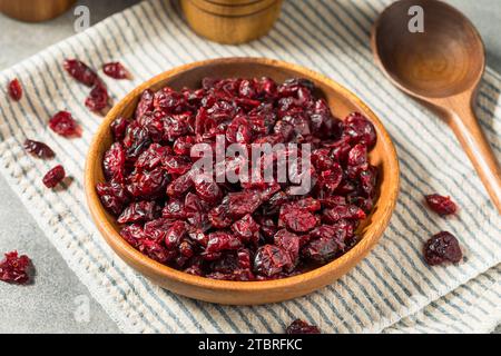 Organic Raw Dry Cranberries in a Wooden Bowl Stock Photo
