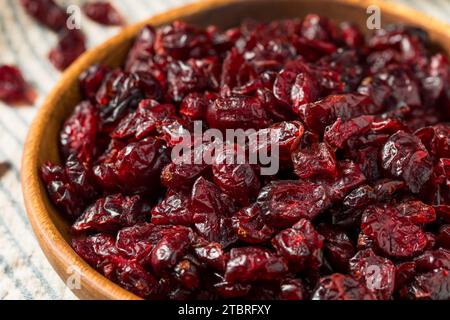 Organic Raw Dry Cranberries in a Wooden Bowl Stock Photo
