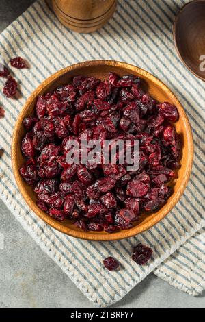 Organic Raw Dry Cranberries in a Wooden Bowl Stock Photo