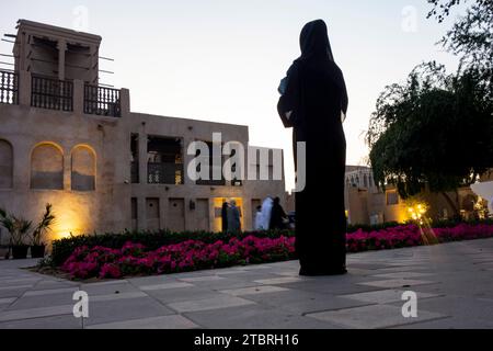 Silhouette of a woman in hijab standing  in the Al Shindagha Heritage District, Dubai, UAE. Stock Photo