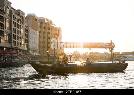 Young couple returning from a watertaxi sightseeing tour on Dubai Creek, Dubai, UAE. Stock Photo