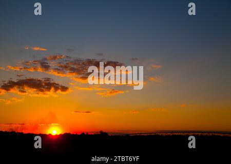 Fiery Sunset Over Silhouetted Landscape in Empire, Michigan Stock Photo