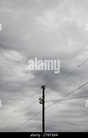 Solitary Utility Pole Against Overcast Sky in America Stock Photo