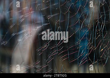 Intricate Shatter Pattern on Glass Pane in Urban Setting Stock Photo