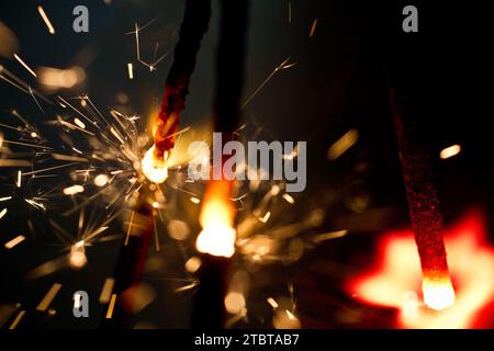 Close-up of Sparkling Embers from Handheld Sparklers in Dark Background Stock Photo