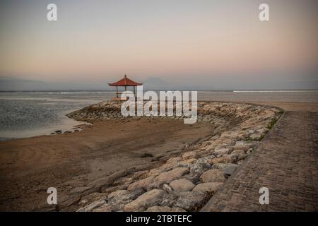 Morning landscape taken at the sandy beach, view over the sea to the volcano Mount Agung, panorama of the sunrise at the sandy beach of Sanur, Bali, Indonesia Stock Photo