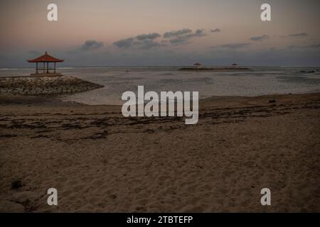 Morning landscape taken at the sandy beach, view over the sea to the volcano Mount Agung, panorama of the sunrise at the sandy beach of Sanur, Bali, Indonesia Stock Photo