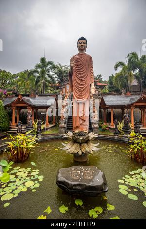 A Buddhist temple in the evening in the rain, the Brahmavihara-Arama temple has beautiful gardens and is also home to a monastery, tropical plants near Banjar, Bali Stock Photo