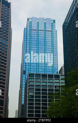 Urban Canyon: Glass Skyscraper Amid High-Rises in Chicago's Business District Stock Photo