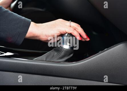 Woman shift gears in car Stock Photo