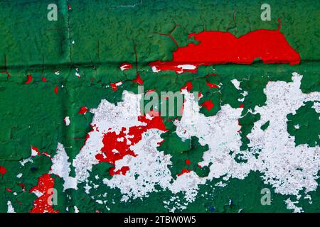 Close-up of Weathered Green, Red and White Peeling Paint Texture Stock Photo