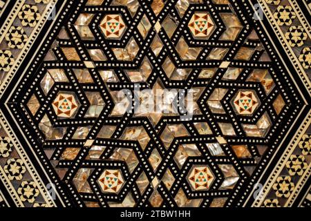 hexagonal middle eastern, moroccan inlaid box design on patterned rug Stock Photo