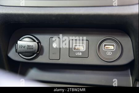 12V socket, USB port, AUX port on car dashboard and car cigarette lighter. Electric detail in car. Stock Photo