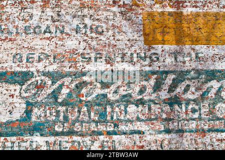 Vintage Urban Decay - Peeling Paint on Weathered Brick Wall Stock Photo