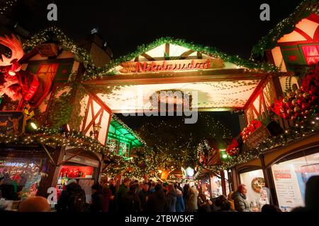 Cologne, Germany December 06 2023: entrance portal to the christmas market Nikolausdorf in the old town of cologne in the evening Stock Photo