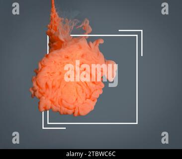 Splash of orange ink and frame on grey background Stock Photo