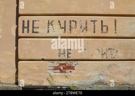 No Smoking in Russian painted on a wall on a crumbling building at Daugavpils Fortress in Latvia Stock Photo