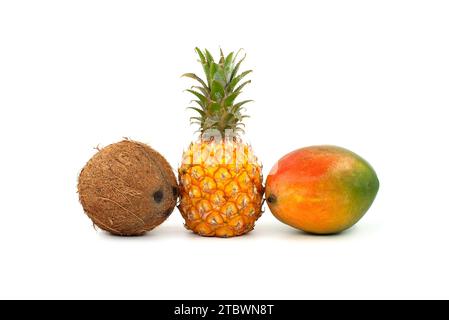 Whole coconut, pineapple fruit and multicolored mango isolated on a white background Stock Photo