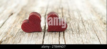 Two wooden hearts on the cracked rustic wooden table Stock Photo