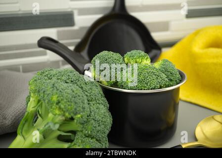 Fresh broccoli florets preparation for cooking on the kitchen table Stock Photo