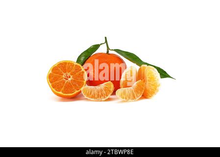 Tangerine, clementine or mandarin orange fruit with green leaves, peeled segments and half-cut citrus fruit lying in front isolated on white Stock Photo